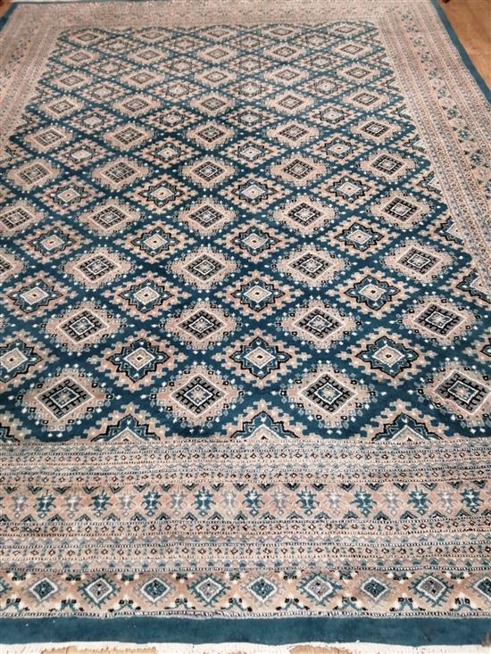 A teal ground Persian design carpet 366 x 270cm